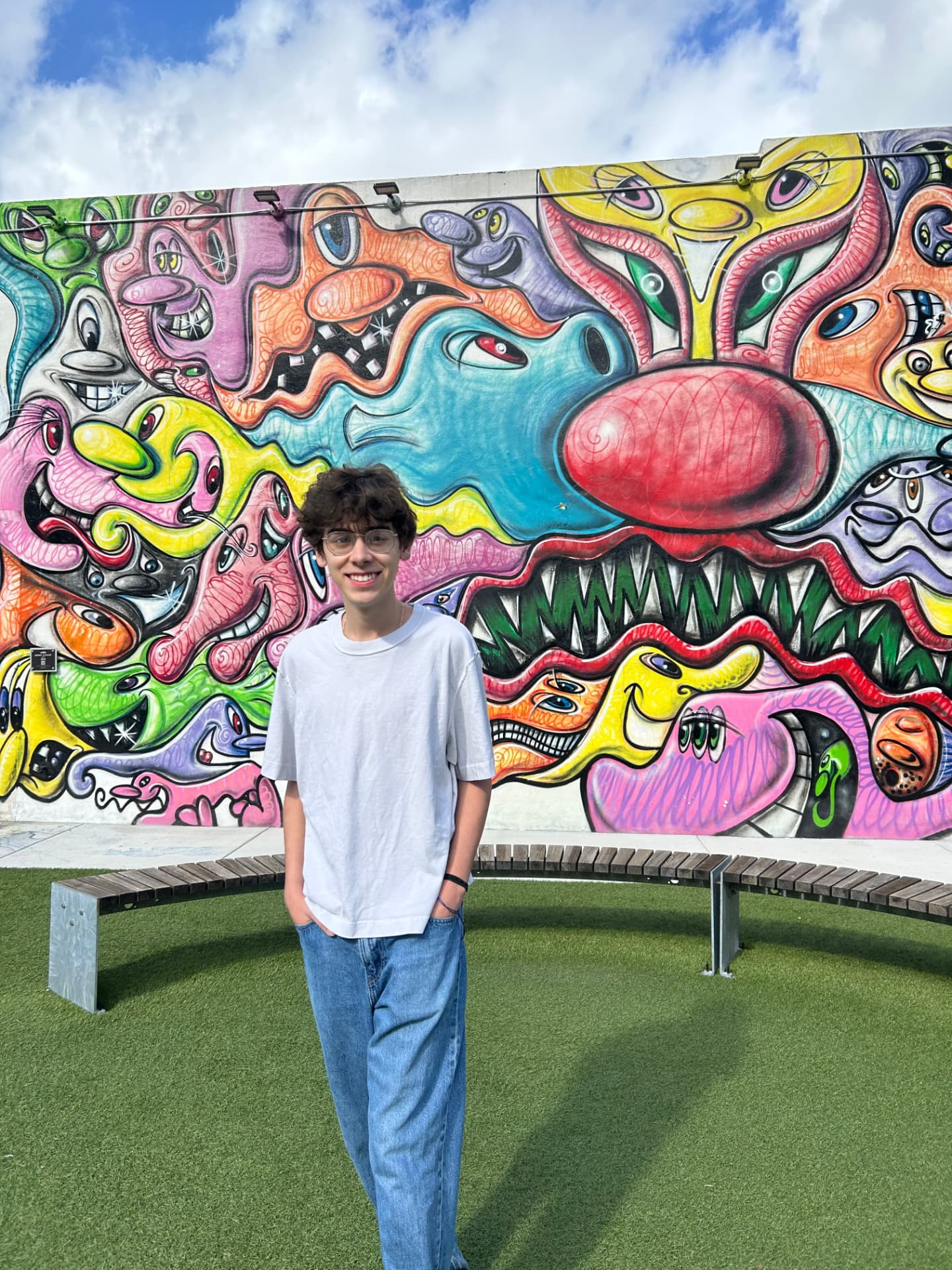 Christopher in front of a street art mural